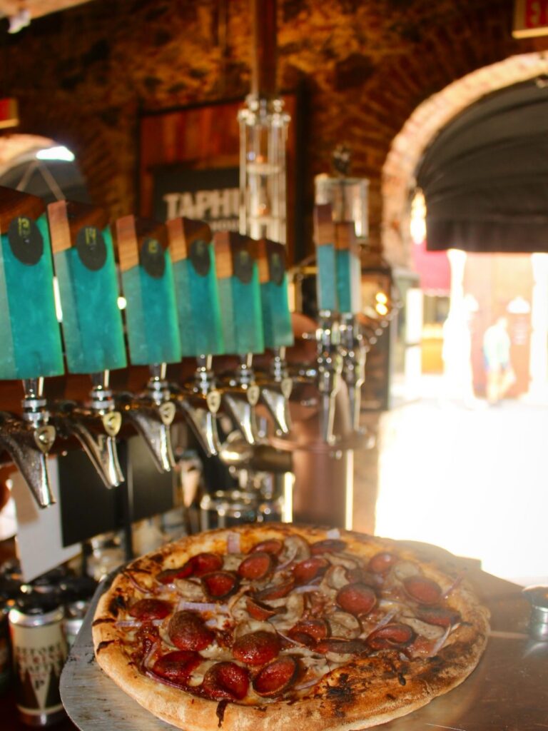 Pepperoni pizza in front of the taps at Taphus Beer House, St. Thomas
